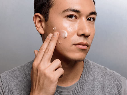 a man rubs on anti-aging skincare without retinol