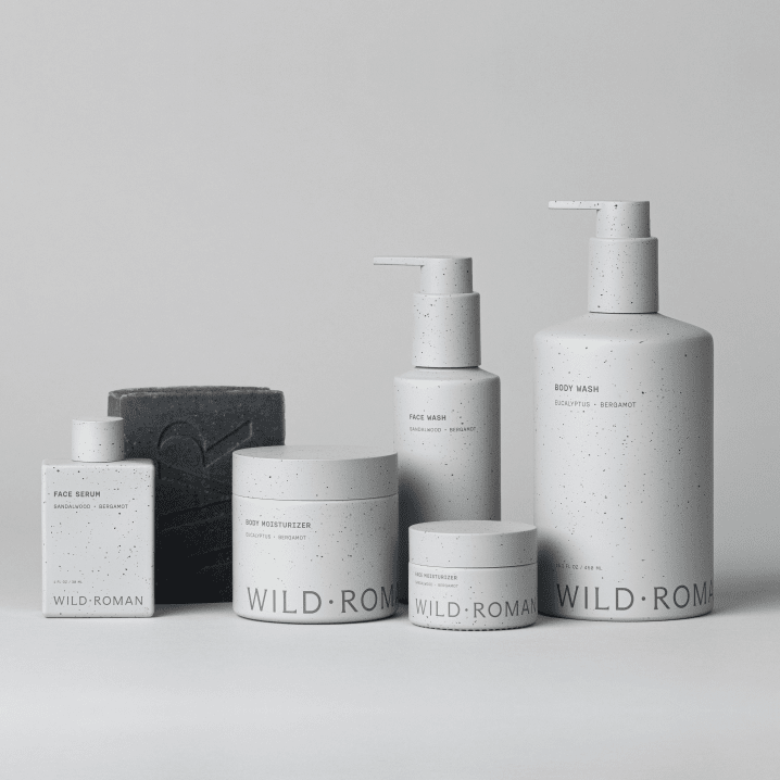 Collection of Wild Roman Men's skincare products on a light gray background