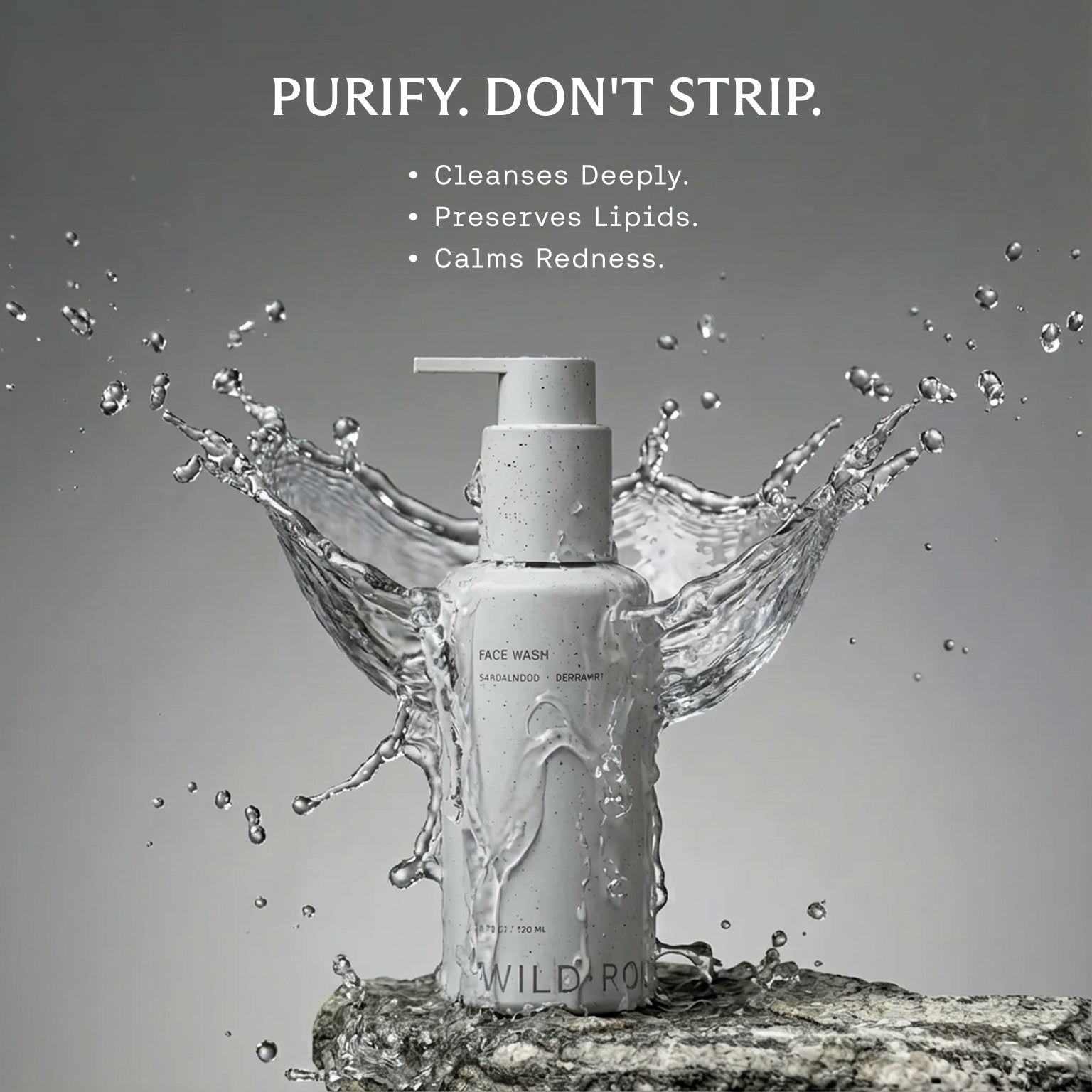 Bottle of Wild Botanics face wash with water splashes on a gray background