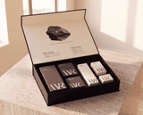 Skincare product set with 'WR' branding on a wooden surface