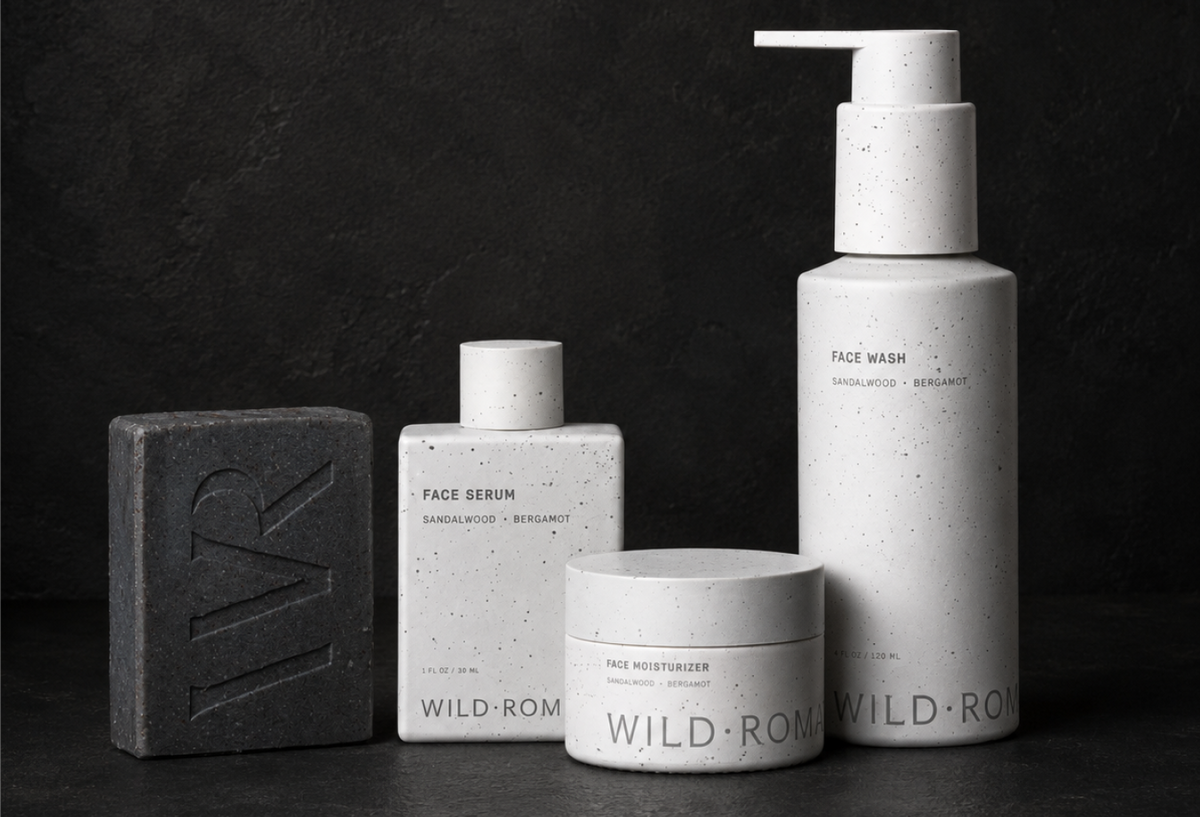 Wild Roman bar soap, Face Serum, Face Moisturizer and Face Wash on a dark stone background